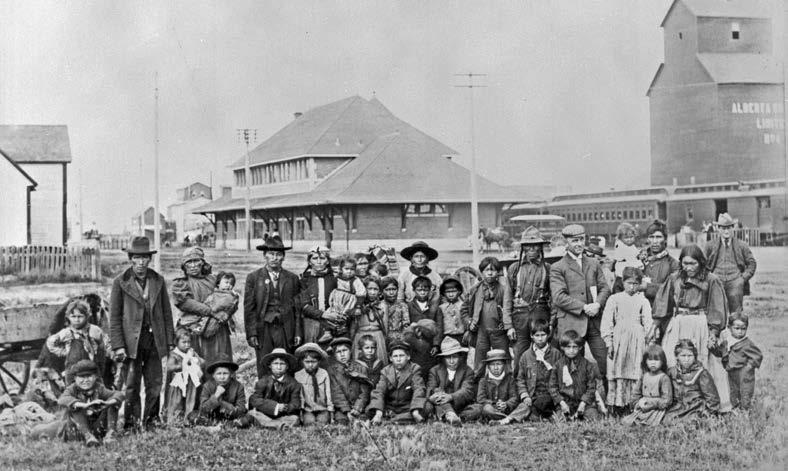 A group of students and parents from the Saddle Lake Reserve, en route to the Methodist-operated school in Red Deer, Alberta. Woodruff, Library and Archives Canada, PA-040715.