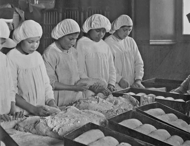 Students working in the kitchen at the Cross Lake, Manitoba, school in the early 1920s. St. Boniface Historical Society Archives; Roman Catholic Archbishop of Keewatin-The Pas Fonds; N1826.